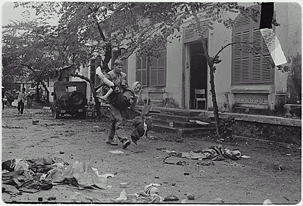 US Marine Carries Elderly Vietnamese Woman, Battle of Hue, South Vietnam, February 1968