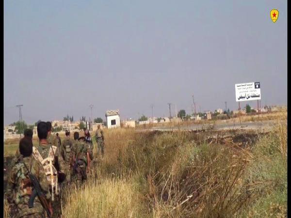 Kurdish People's Protection Units march into Tell Abyad, June 2015