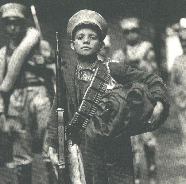 A boy with Mexican Federal Army Ammunition; Mexico, 1913