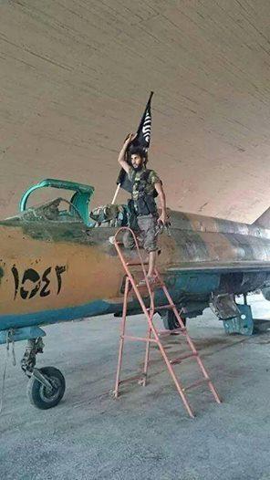 Islamic State Fighter Poses Next to Captured Aircraft, Al Tabqah Airbase Syria, August 2014