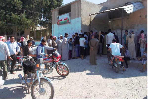 Residents Lining Up for Bread Distribution; Tal Abyad, Syria, June 2015