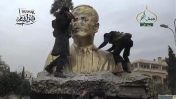 Faylaq Al Sham (Islamic Front Affiliated) Fighters Smash a Statue of Hafez Al Assad