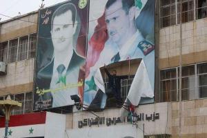 Rebels Tear down a Poster of Bashar Al Assad Outside the Idlib Baath Party Building