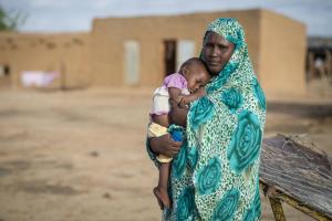 Fatima, 33 years old, holding her baby, cured from severe acute malnutrition