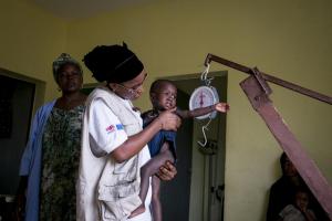 Awa Cheikhna Tansian, a nutrition supervisor working with AAH, weighing a child