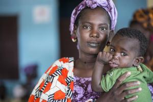 Fatou, 22 years old, carrying her son Adama