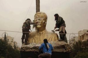 Faylaq Al Sham (Islamic Front Affiliated) Fighters Smash a Statue of Hafez Al Assad